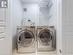 Washroom featuring tile patterned flooring and separate washer and dryer