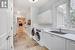 Clothes washing area with cabinets, sink, and washing machine and dryer