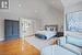 Bedroom featuring ensuite bath, wood-type flooring, and high vaulted ceiling