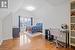 Bedroom with vaulted ceiling and hardwood / wood-style floors