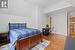 Bedroom featuring vaulted ceiling and light hardwood / wood-style flooring