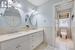 Bathroom featuring vanity, toilet, tile patterned flooring, and tile walls