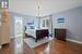 Bedroom with an inviting chandelier, wood-type flooring, ensuite bathroom, and sink