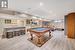 Recreation room featuring bar, pool table, and light hardwood / wood-style flooring