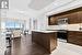 Kitchen featuring sink, decorative backsplash, a kitchen island with sink, stainless steel appliances, and dark brown cabinets