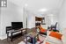 Living room with crown molding and dark hardwood / wood-style floors