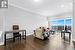 Living room featuring ornamental molding and dark hardwood / wood-style flooring