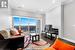 Living room featuring dark hardwood / wood-style flooring and ornamental molding