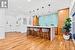 Kitchen with hanging light fixtures, light hardwood / wood-style flooring, a kitchen breakfast bar, and a kitchen island