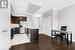 Kitchen featuring dark hardwood / wood-style floors, sink, a kitchen island with sink, dark brown cabinetry, and stainless steel appliances