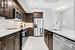 Kitchen featuring appliances with stainless steel finishes, sink, backsplash, light tile patterned floors, and dark brown cabinetry