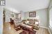 Living room with lofted ceiling, a chandelier, and light hardwood / wood-style flooring