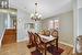 Dining area with lofted ceiling, a notable chandelier, and light wood-type flooring