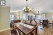 Dining room featuring an inviting chandelier, lofted ceiling, and light hardwood / wood-style floors