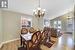 Dining area with lofted ceiling, a notable chandelier, and light hardwood / wood-style flooring