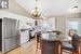 Kitchen with a kitchen island, pendant lighting, white cabinetry, sink, and stainless steel appliances