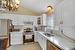 Kitchen with white cabinetry, sink, vaulted ceiling, and appliances with stainless steel finishes