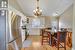 Kitchen featuring lofted ceiling, sink, white cabinets, and appliances with stainless steel finishes