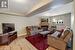 Living room with a tile fireplace, a textured ceiling, and light hardwood / wood-style flooring