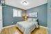 Bedroom with a textured ceiling and light wood-type flooring