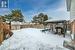 Yard covered in snow featuring a gazebo