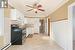 Eating area in foreground and kitchen.  Stove and fridge included.  Disclosure - hood fan is not working.