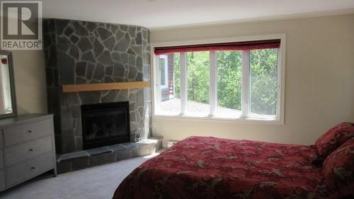 2 Hillside Drive, Humber Valley Resort, NL - Indoor Photo Showing Bedroom With Fireplace