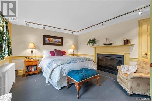 128 Queen Street, Saint Andrews, NB - Indoor Photo Showing Bedroom With Fireplace