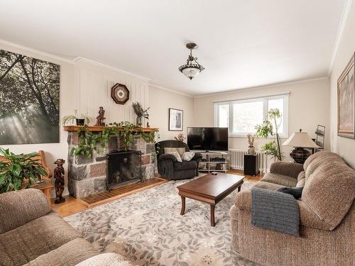 Living room - 3 Rue Perrault, Sainte-Anne-De-Bellevue, QC - Indoor Photo Showing Living Room With Fireplace