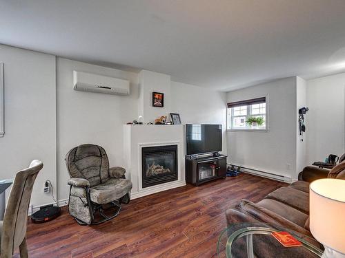 Basement - 304-306-13625 Rue Therrien, Mirabel, QC - Indoor Photo Showing Living Room With Fireplace