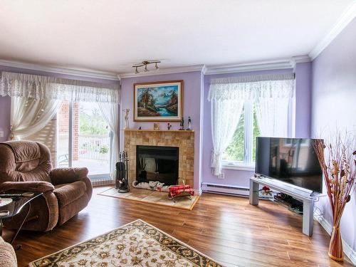 Salon - 133-30 Rue De Courcelle, Repentigny (Repentigny), QC - Indoor Photo Showing Living Room With Fireplace