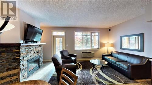 500 Bighorn  Boulevard Unit# 523 B, Radium Hot Springs, BC - Indoor Photo Showing Living Room With Fireplace