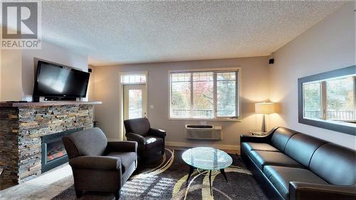 500 Bighorn  Boulevard Unit# 523 B, Radium Hot Springs, BC - Indoor Photo Showing Living Room With Fireplace