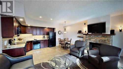 500 Bighorn  Boulevard Unit# 523 B, Radium Hot Springs, BC - Indoor Photo Showing Living Room With Fireplace