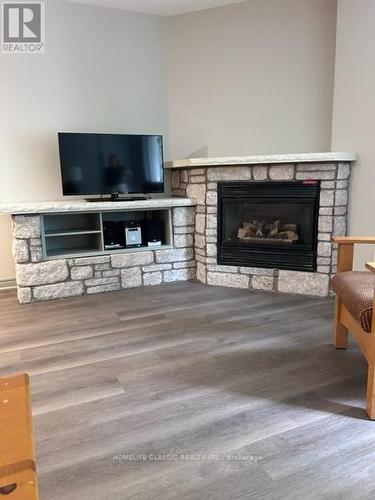 2312-13 - 90 Highland Drive, Oro-Medonte, ON - Indoor Photo Showing Living Room With Fireplace