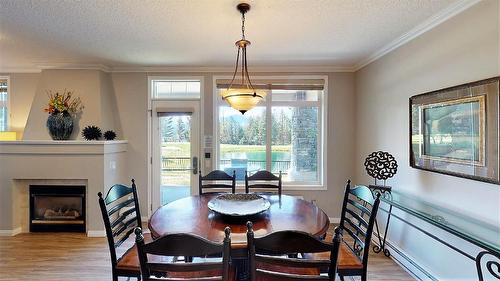 104 K - 100 Bighorn Boulevard, Radium Hot Springs, BC - Indoor Photo Showing Dining Room With Fireplace