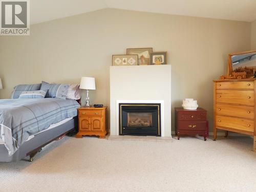 290 Hill Street, Burns Lake, BC - Indoor Photo Showing Bedroom With Fireplace