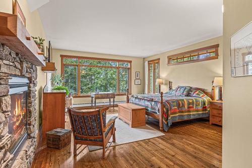 1403 Deer Ridge Road, Golden, BC - Indoor Photo Showing Bedroom With Fireplace