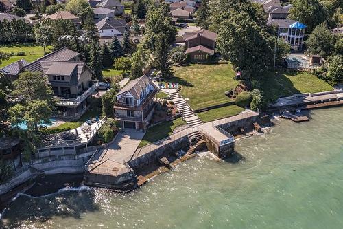 Providing a 150 foot breathtaking waterfront frontage showcasing large separate boathouse - 23 Winona Park Road, Stoney Creek, ON - Outdoor
