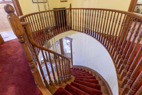 A dramatic circular oak staircase leads your way to a large upper landing - 23 Winona Park Road, Stoney Creek, ON - Indoor Photo Showing Other Room