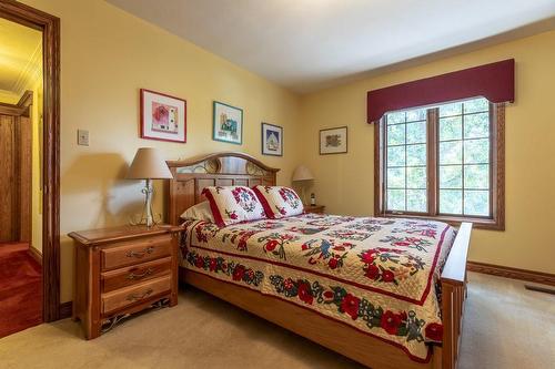 Wood trim work adorns the windows and baseboards - 23 Winona Park Road, Stoney Creek, ON - Indoor Photo Showing Bedroom