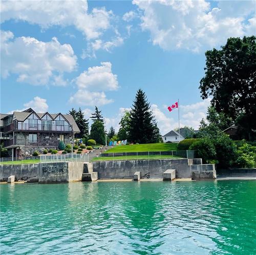 Set on a private roadway of just 16 homes, this hidden gem is so close to hustle and bustle and yet worlds away in terms of privacy and comfort - 23 Winona Park Road, Stoney Creek, ON - Outdoor With Body Of Water