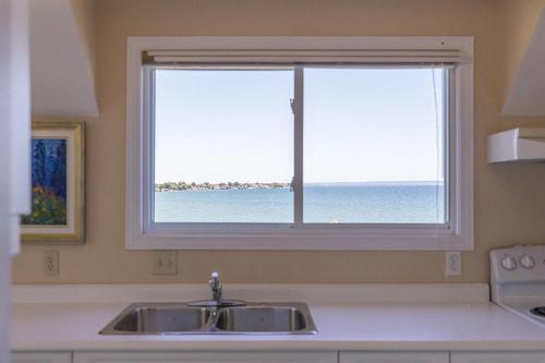 Imagine awakening to this view as you look west toward Hamilton.  Its easy to imagine this space to work from home and lessen your commute into Toronto - 23 Winona Park Road, Stoney Creek, ON - Indoor Photo Showing Kitchen With Double Sink