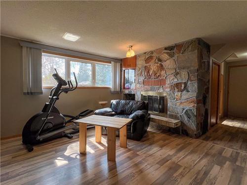 526 Third Avenue, Reston, MB - Indoor Photo Showing Gym Room With Fireplace