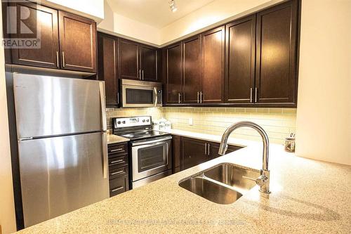 #602 -2480 Prince Michael Dr, Oakville, ON - Indoor Photo Showing Kitchen With Double Sink