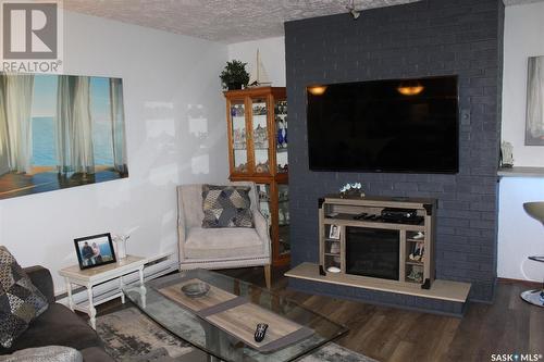 13 228 3Rd Street Ne, Weyburn, SK - Indoor Photo Showing Living Room With Fireplace