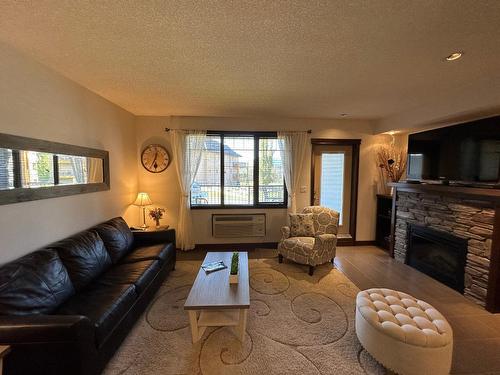 712 - 700 Bighorn Boulevard, Radium Hot Springs, BC - Indoor Photo Showing Living Room With Fireplace