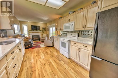 3808 Sawgrass Drive, Osoyoos, BC - Indoor Photo Showing Kitchen With Fireplace With Double Sink