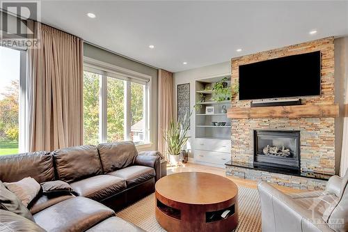Open concept Family Room with views of the backyard. - 375 Ridgeside Farm Drive, Kanata, ON - Indoor Photo Showing Living Room With Fireplace