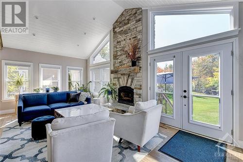 Your family's new favourite space - beautiful Sunroom with wood burning fireplace. - 375 Ridgeside Farm Drive, Kanata, ON - Indoor Photo Showing Living Room With Fireplace